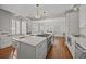 Open-concept kitchen with an island, seating, and stainless steel appliances, flowing into the dining area at 34 Pinckney St, Charleston, SC 29401