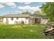 Exterior shot of a charming home with a spacious backyard and green lawn at 407 Tammie Ave, Goose Creek, SC 29445