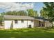 Exterior of a white brick home with a backyard and green lawn at 407 Tammie Ave, Goose Creek, SC 29445