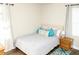 Bright bedroom with a bed, blue accents, and a wooden side table with two drawers at 407 Tammie Ave, Goose Creek, SC 29445