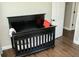 Bedroom featuring a black crib with bedding and a door at 407 Tammie Ave, Goose Creek, SC 29445