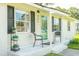 Inviting front porch with stylish chairs, a vibrant door, and decorative details at 407 Tammie Ave, Goose Creek, SC 29445