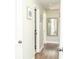 Bright hallway with hardwood floors, white doors, and framed artwork at 407 Tammie Ave, Goose Creek, SC 29445