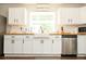 Bright kitchen boasts white cabinets, wood counters, subway tile backsplash, and stainless steel appliances at 407 Tammie Ave, Goose Creek, SC 29445