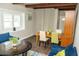 Well-lit living area with a large window, blue sofas, round table, and dining space at 407 Tammie Ave, Goose Creek, SC 29445