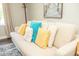 Close-up view of a cozy couch with decorative pillows in a naturally lit living room at 407 Tammie Ave, Goose Creek, SC 29445