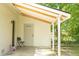 Covered porch with white brick, chair, and entrance at 407 Tammie Ave, Goose Creek, SC 29445