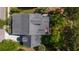 Aerial view of the backyard, outdoor deck, manicured lawn, and putting green surrounded by mature trees at 4082 Blackmoor St, Mount Pleasant, SC 29466
