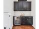 A wet bar features dark cabinets, a mini-fridge, and white countertops at 4082 Blackmoor St, Mount Pleasant, SC 29466