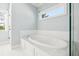 Bright bathroom with a white soaking tub and bright light blue walls at 4082 Blackmoor St, Mount Pleasant, SC 29466
