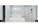 Modern bathroom featuring a soaking tub and glass-enclosed shower at 4082 Blackmoor St, Mount Pleasant, SC 29466