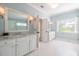 Light-filled bathroom with double vanity and bright white tile flooring at 4082 Blackmoor St, Mount Pleasant, SC 29466