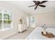Sunlit bedroom features a ceiling fan, and a door leading to a balcony at 4082 Blackmoor St, Mount Pleasant, SC 29466