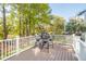 Outdoor deck featuring a dark metal table and chairs with views of lush trees at 4082 Blackmoor St, Mount Pleasant, SC 29466