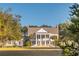 Elegant white home with symmetrical design and beautiful landscaping at 4082 Blackmoor St, Mount Pleasant, SC 29466