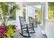 Inviting porch featuring rocking chairs, throw pillows, and colorful potted plants at 4082 Blackmoor St, Mount Pleasant, SC 29466
