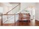 Hallway featuring piano, hardwood floors, and staircase with white railings at 4082 Blackmoor St, Mount Pleasant, SC 29466