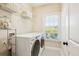 Laundry room with new side-by-side washer and dryer and wire shelving at 4082 Blackmoor St, Mount Pleasant, SC 29466