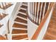 Elegant curved staircase featuring hardwood steps and white railing at 4082 Blackmoor St, Mount Pleasant, SC 29466