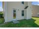 The home features a door in the backyard leading inside and a grassy lawn at 409 Thoroughbred Dr, Moncks Corner, SC 29461