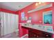 Bright bathroom featuring a shower with white curtain, vanity with marble countertop, and colorful red walls at 409 Thoroughbred Dr, Moncks Corner, SC 29461