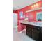 Bright bathroom featuring a shower with white curtain, vanity with marble countertop, and colorful red walls at 409 Thoroughbred Dr, Moncks Corner, SC 29461