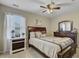 Bedroom features two dressers, bed with patterned comforter, ceiling fan, window, and neutral-colored walls at 409 Thoroughbred Dr, Moncks Corner, SC 29461