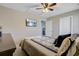 Bedroom features a bed with patterned comforter, TV, ceiling fan, and a view to another room at 409 Thoroughbred Dr, Moncks Corner, SC 29461