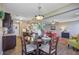 Open-concept dining room features a round table, pendant lighting, and flows into the living area at 409 Thoroughbred Dr, Moncks Corner, SC 29461