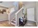 Open entryway with a staircase and view of the kitchen, and entry door at 409 Thoroughbred Dr, Moncks Corner, SC 29461