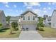 Charming two-story home with a well-manicured lawn and a two-car garage at 409 Thoroughbred Dr, Moncks Corner, SC 29461