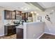 Well-lit kitchen boasts dark cabinetry, stainless steel appliances, and a breakfast bar for casual dining at 409 Thoroughbred Dr, Moncks Corner, SC 29461