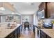Bright, open kitchen with stainless steel appliances and dark cabinetry overlooking the dining area at 409 Thoroughbred Dr, Moncks Corner, SC 29461