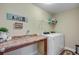 Functional laundry room with countertop, shelving, and washer and dryer units, and decorative Laundry sign on the wall at 409 Thoroughbred Dr, Moncks Corner, SC 29461
