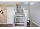 Well-lit staircase with wood and white banisters, leading to the upper level of the home at 409 Thoroughbred Dr, Moncks Corner, SC 29461