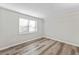 Clean, light-filled bedroom with wood-look floors and a window at 415 Parkdale Dr # 2B, Charleston, SC 29414