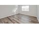 Bright, empty bedroom with wood-look flooring, trim, and window at 415 Parkdale Dr # 2B, Charleston, SC 29414