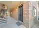 Brick condo building exterior with stairs leading to upper units, a black door, and an outdoor welcome mat at 415 Parkdale Dr # 2B, Charleston, SC 29414