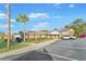 Low brick community building with parking, landscaping, sidewalk, and small covered front porch at 415 Parkdale Dr # 2B, Charleston, SC 29414