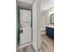Convenient laundry room with stacked washer and dryer; bathroom in background at 415 Parkdale Dr # 2B, Charleston, SC 29414