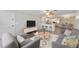 Open-concept living area with modern furnishings, a breakfast bar, and seamless flow to the kitchen at 415 Parkdale Dr # 2B, Charleston, SC 29414