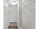 Bright walk-in closet featuring white shelving and hardwood flooring at 415 Parkdale Dr # 2B, Charleston, SC 29414