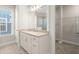 Bathroom with granite countertop, white cabinets, window and doorway to walk-in closet at 4996 Song Sparrow Way, Summerville, SC 29483