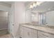 Bathroom with white cabinets, granite countertop, large mirror and access to the closet at 4996 Song Sparrow Way, Summerville, SC 29483