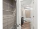 Bathroom featuring modern vanity, tiled shower, and storage racks, easily accessible from open door at 4996 Song Sparrow Way, Summerville, SC 29483