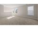 Spacious bedroom featuring three large windows and neutral carpet at 4996 Song Sparrow Way, Summerville, SC 29483