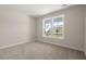 Bedroom with neutral carpet, light walls, and a window with a view of the neighborhood at 4996 Song Sparrow Way, Summerville, SC 29483