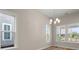 Dining room with large windows providing ample natural light and a view of the neighborhood at 4996 Song Sparrow Way, Summerville, SC 29483