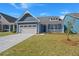 Charming blue home with a two-car garage and inviting front porch at 4996 Song Sparrow Way, Summerville, SC 29483