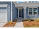 Close-up of a charming blue home's front porch with well-manicured landscaping at 4996 Song Sparrow Way, Summerville, SC 29483